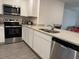 Beautiful kitchen featuring granite countertops, white cabinets, and stainless steel appliances at 439 Mulberry Ct, Kissimmee, FL 34759