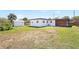 The backyard features green grass and an outbuilding for storage at 4429 Rossmore Dr, Orlando, FL 32810