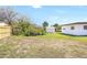 Expansive backyard featuring a storage shed, mature trees, and lush grass, providing an ideal outdoor space at 4429 Rossmore Dr, Orlando, FL 32810