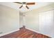 This bedroom features hardwood floors, a ceiling fan, and a closet at 4429 Rossmore Dr, Orlando, FL 32810