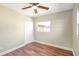 Bedroom featuring wood floors, a ceiling fan, and closet at 4429 Rossmore Dr, Orlando, FL 32810