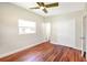 Bedroom featuring wood floors, a ceiling fan, and closet at 4429 Rossmore Dr, Orlando, FL 32810