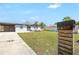 Exterior view of home showing front yard, mailbox, modern xeriscape and covered parking at 4429 Rossmore Dr, Orlando, FL 32810