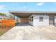 Inviting single-story home with a convenient carport, modern fence, and decorative window, adding charm and functionality at 4429 Rossmore Dr, Orlando, FL 32810