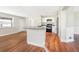 Open-concept kitchen with stainless steel appliances, center island, and wood flooring at 4429 Rossmore Dr, Orlando, FL 32810
