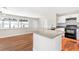 Modern kitchen featuring an eat-in island, modern appliances and beautiful flooring at 4429 Rossmore Dr, Orlando, FL 32810