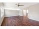 Bright living room with wood floors, a ceiling fan, and natural light flowing into the adjacent dining area at 4429 Rossmore Dr, Orlando, FL 32810