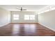 Spacious living room with wood floors, a ceiling fan, and an abundance of natural light from several windows at 4429 Rossmore Dr, Orlando, FL 32810