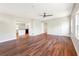 Open-concept living room with wood floors, recessed lighting, a ceiling fan, and access to kitchen at 4429 Rossmore Dr, Orlando, FL 32810