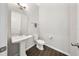 Stylish half-bathroom featuring a pedestal sink, modern fixtures, and neutral decor at 450 Windmill Palm Cir, Altamonte Springs, FL 32701