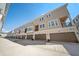 Exterior view of townhomes with multiple floors, garages, and balconies on a sunny day at 450 Windmill Palm Cir, Altamonte Springs, FL 32701