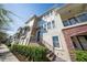 Multi-story townhouse featuring brick accents, a private entry, and a well-maintained landscape at 450 Windmill Palm Cir, Altamonte Springs, FL 32701