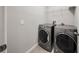 Modern laundry room features a washer and dryer with shelving above for storage at 450 Windmill Palm Cir, Altamonte Springs, FL 32701