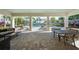 Covered community area overlooks a pool with tables and chairs and additional lounge chairs nearby at 450 Windmill Palm Cir, Altamonte Springs, FL 32701