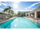 Community pool with lounge chairs, palm trees, and a nearby amenity center at 450 Windmill Palm Cir, Altamonte Springs, FL 32701