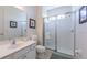 Clean bathroom with a single sink vanity, glass shower, and framed artwork at 4507 Monado Dr, Kissimmee, FL 34746