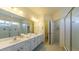 Spacious bathroom featuring a double sink vanity, walk-in shower, and separate toilet area at 4507 Monado Dr, Kissimmee, FL 34746