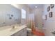Well-lit bathroom with a tub/shower combination, modern vanity, and decorative accents at 4507 Monado Dr, Kissimmee, FL 34746