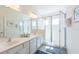 Bright bathroom featuring a double sink vanity and glass shower doors at 4507 Monado Dr, Kissimmee, FL 34746