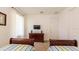 Inviting bedroom featuring two twin beds and large dresser with TV at 4507 Monado Dr, Kissimmee, FL 34746