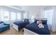 Comfortable bedroom with two beds, soft lighting, stylish decor, and cozy armchair at 4507 Monado Dr, Kissimmee, FL 34746