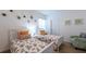 Bright bedroom featuring two beds, modern decor, and a comfortable armchair at 4507 Monado Dr, Kissimmee, FL 34746