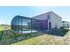 Exterior view of the home featuring a screened-in patio and refreshing swimming pool at 4507 Monado Dr, Kissimmee, FL 34746