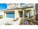 Inviting front of home, featuring a blue garage door, modern landscaping and manicured beds at 4507 Monado Dr, Kissimmee, FL 34746