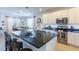 Bright, spacious kitchen with white cabinetry, stainless steel appliances, and large island with seating at 4507 Monado Dr, Kissimmee, FL 34746
