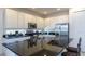 Modern kitchen with stainless steel appliances, white cabinetry, and a large black island countertop at 4507 Monado Dr, Kissimmee, FL 34746