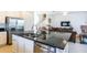 Open concept kitchen featuring a large island, stainless steel appliances and an adjacent living area at 4507 Monado Dr, Kissimmee, FL 34746