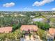Townhome aerial view highlighting a picturesque pond and lush green trees at 4952 Matteo Trl, Orlando, FL 32839
