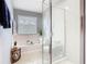 Bright bathroom featuring a bathtub under a window and a glass enclosed shower with toilet at 4952 Matteo Trl, Orlando, FL 32839