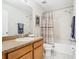 Bathroom featuring a single sink vanity and a shower-tub with a curtain at 4952 Matteo Trl, Orlando, FL 32839