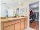 Bathroom features double sinks and a view into the spacious walk-in closet at 4952 Matteo Trl, Orlando, FL 32839