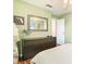 Bedroom featuring a dresser with a mirror and an open door to another space at 4952 Matteo Trl, Orlando, FL 32839