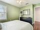 Bedroom featuring a queen size bed with a dresser and a window at 4952 Matteo Trl, Orlando, FL 32839