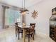 Bright dining room features large window and a decorative light fixture at 4952 Matteo Trl, Orlando, FL 32839