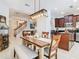 Inviting dining area adjacent to the kitchen and living room with decorative lighting at 4952 Matteo Trl, Orlando, FL 32839