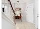 Foyer with tile flooring, staircase, welcome decor, and bright front door sets a welcoming tone for guests and residents at 4952 Matteo Trl, Orlando, FL 32839