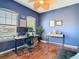 Functional home office with natural light, ample workspace, and a modern adjustable-height desk at 4952 Matteo Trl, Orlando, FL 32839