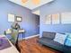 Inviting home office featuring hardwood floors, stylish decor, and a comfortable seating area at 4952 Matteo Trl, Orlando, FL 32839