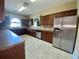 Well-equipped kitchen featuring stainless steel appliances, tile floors and a stylish backsplash at 4952 Matteo Trl, Orlando, FL 32839