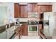 Charming kitchen with stainless steel appliances, granite countertops, and abundant cabinet space at 4952 Matteo Trl, Orlando, FL 32839