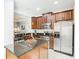 Modern kitchen featuring stainless steel appliances and a central island at 4952 Matteo Trl, Orlando, FL 32839