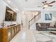 Bright living room with media center, staircase, and front entry views at 4952 Matteo Trl, Orlando, FL 32839