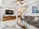 Comfortable living room with media center and staircase views at 4952 Matteo Trl, Orlando, FL 32839