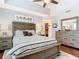Bright main bedroom with hardwood floors featuring a large window and an ensuite bathroom at 4952 Matteo Trl, Orlando, FL 32839