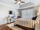 Relaxing main bedroom features a tray ceiling, large window, and hardwood floors at 4952 Matteo Trl, Orlando, FL 32839