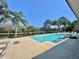 Community pool area featuring clear blue water and ample seating, perfect for relaxing in a tropical setting at 4952 Matteo Trl, Orlando, FL 32839